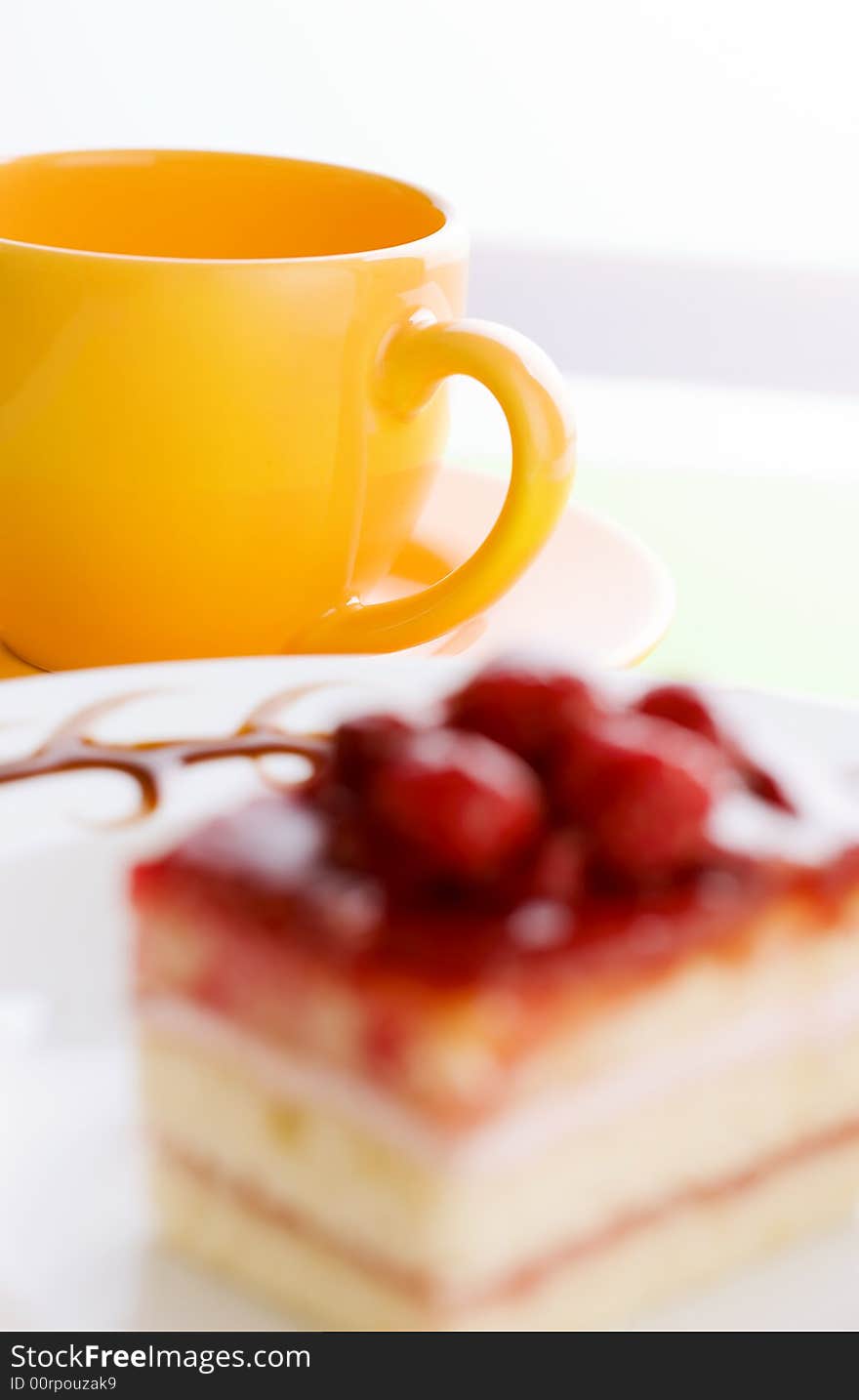 Yellow coffee cup on the coffee table with cake