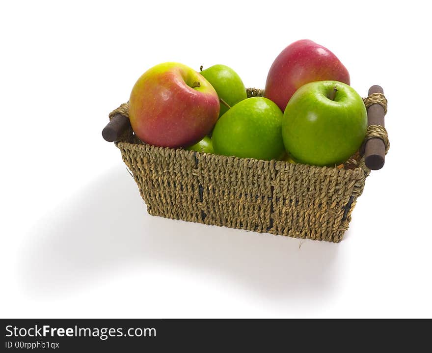 Isolated straw basket filled with apples. Isolated straw basket filled with apples