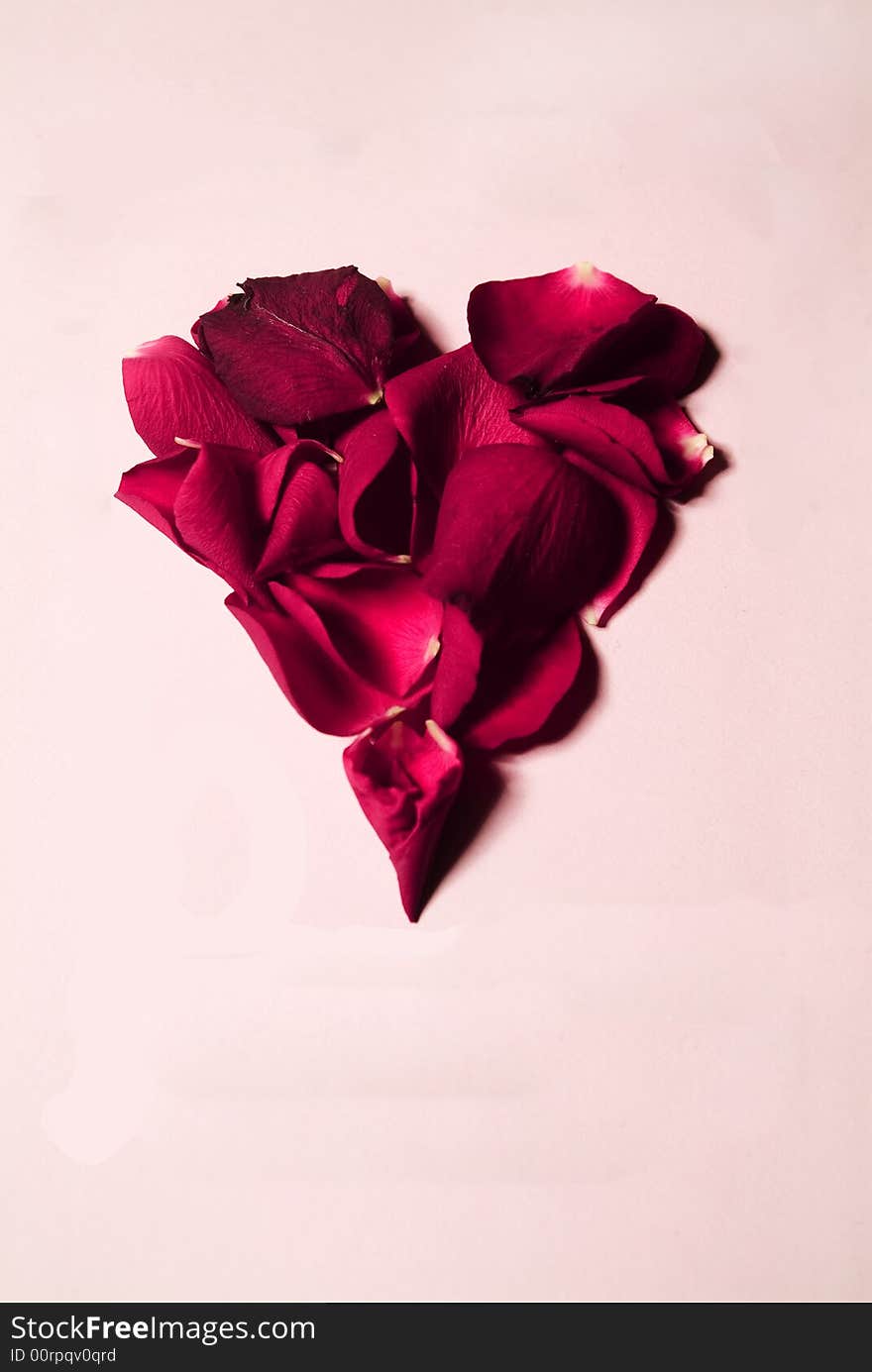 Rose petals shaped as a heart