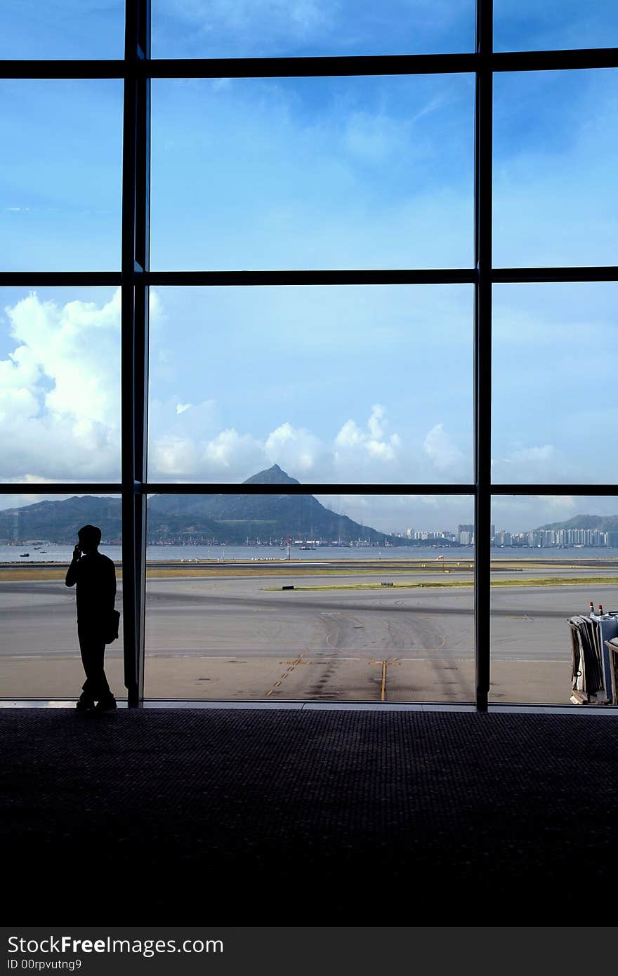 Business traveler makes a call while waiting for his flight