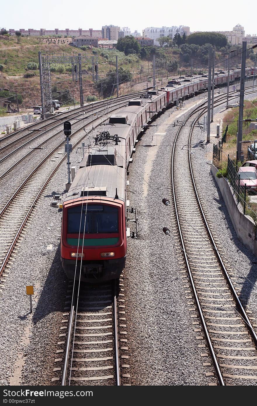 A train passing in the rails for the city. A train passing in the rails for the city