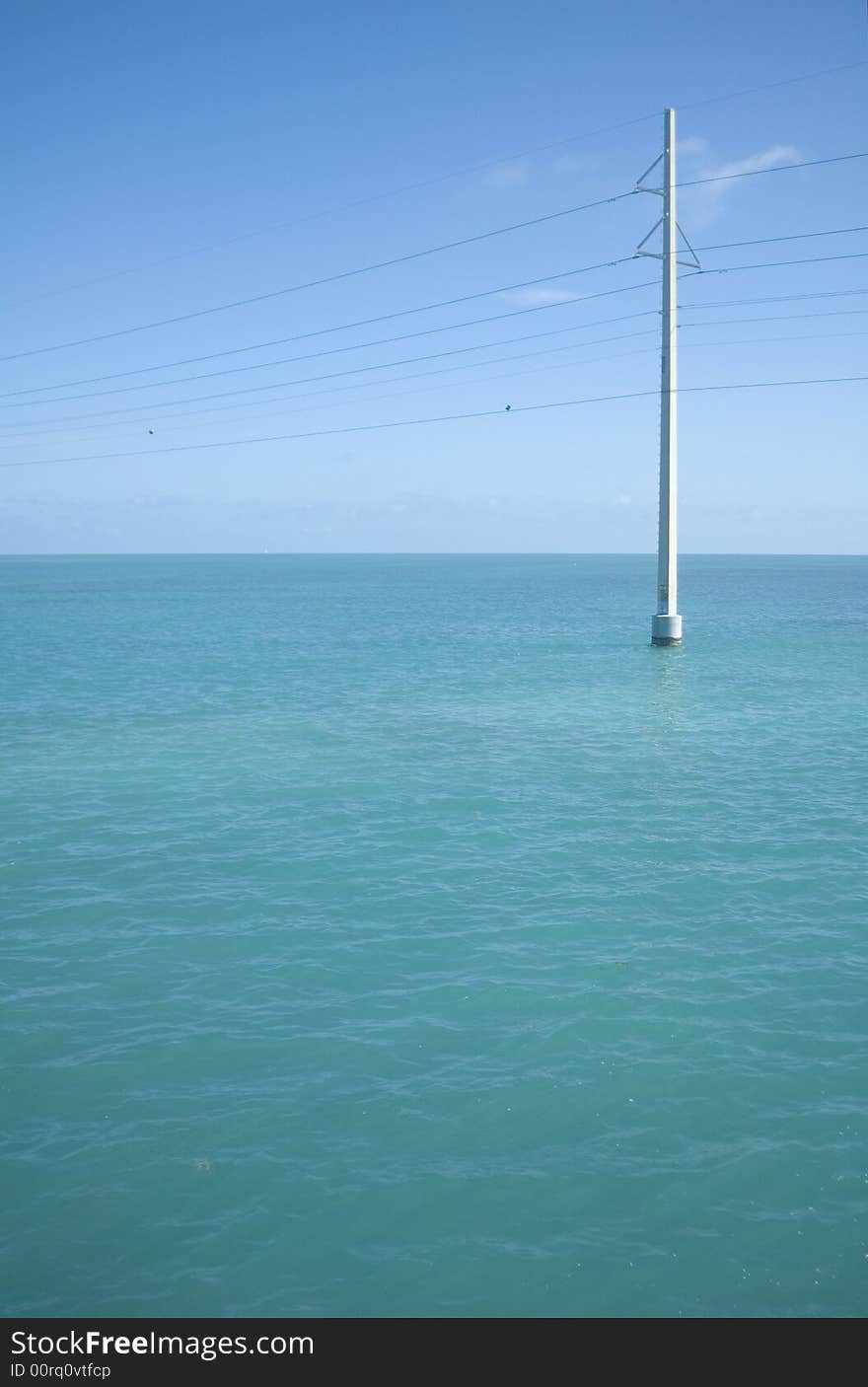 Power lines over Caribbean blue water