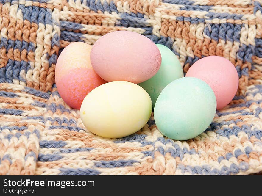 Colorful pastel Easter eggs on handmade crocheted blanket background. Colorful pastel Easter eggs on handmade crocheted blanket background.