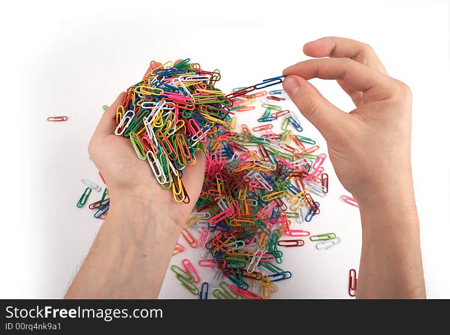 Hands holds paper clips picking chain isolated on white