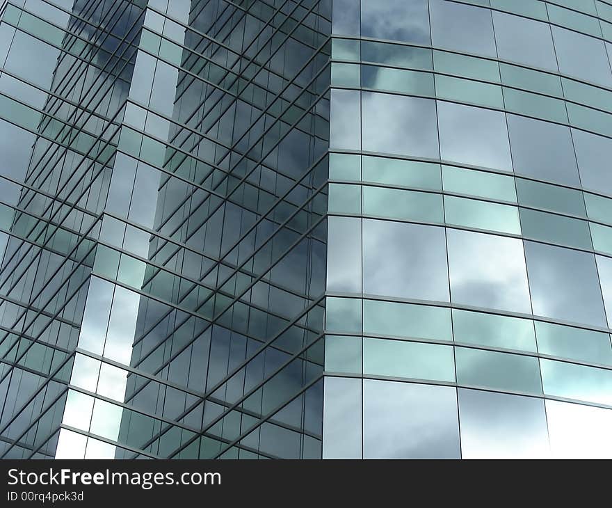 Clouds reflecting in the glass of an urban skyscraper. Clouds reflecting in the glass of an urban skyscraper.