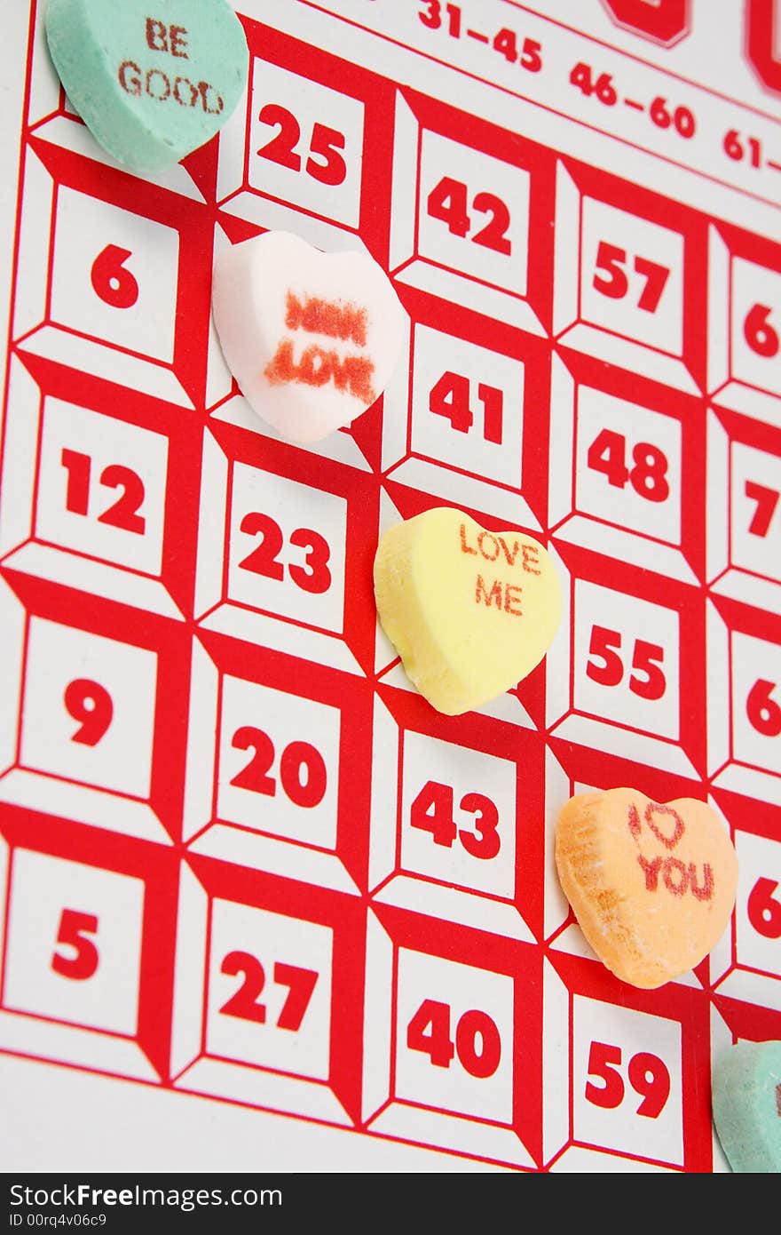 Candy valentines hearts being used as chips in a bingo game. Candy valentines hearts being used as chips in a bingo game