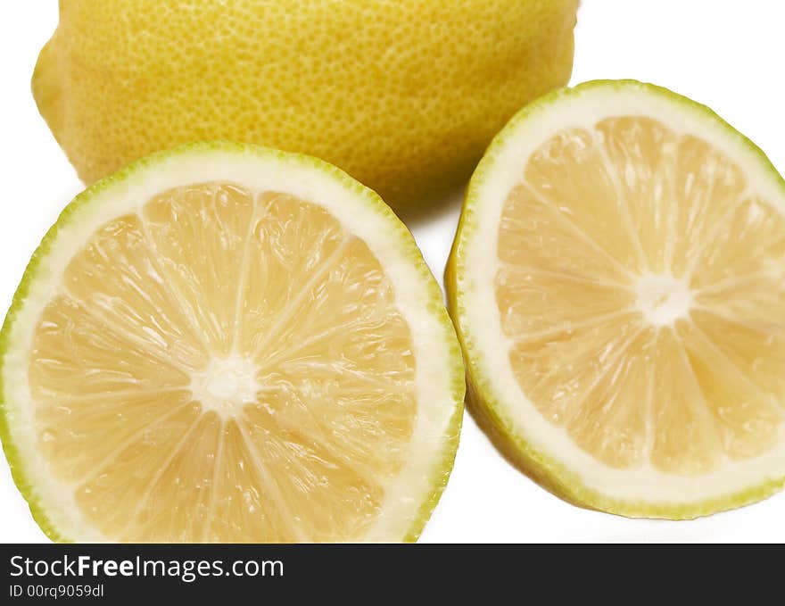 Closeup of three lemons on white