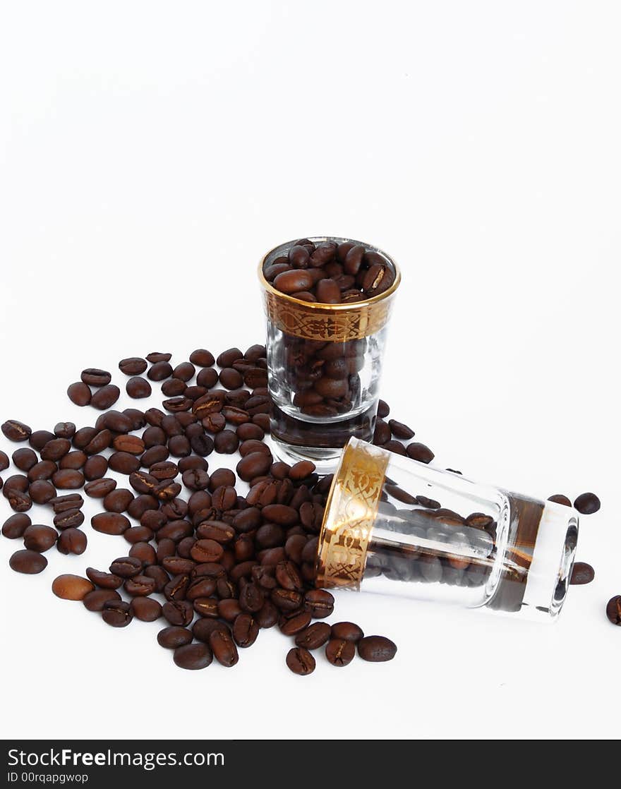 Grains Of Coffee In Glasses On A White Background