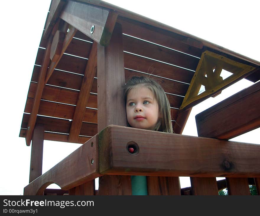 Cute 4 year old girl, playing on a jungle gym big toy. Cute 4 year old girl, playing on a jungle gym big toy.