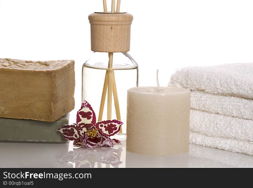 Aroma therapy objects. bottle of esential oil, candle, towels, soap, orchid