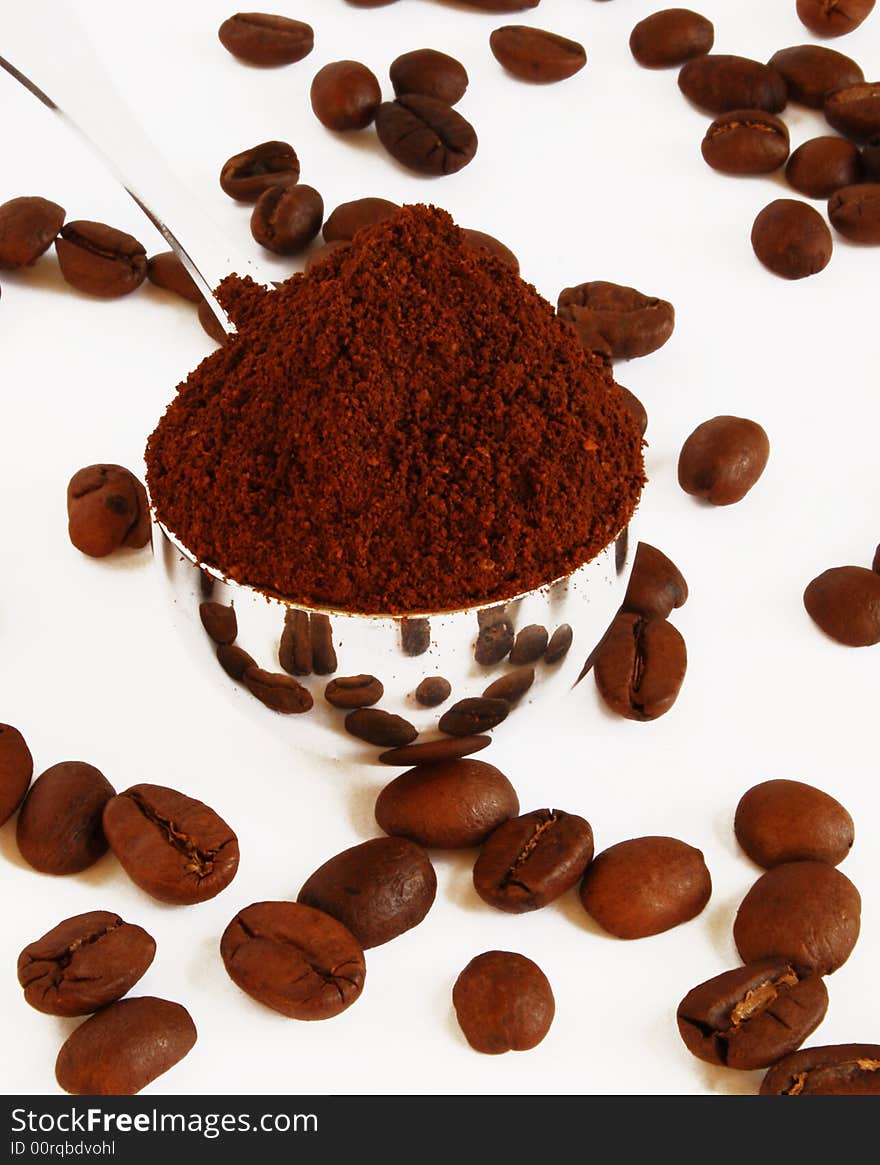 Spoon of coffee on a background grains