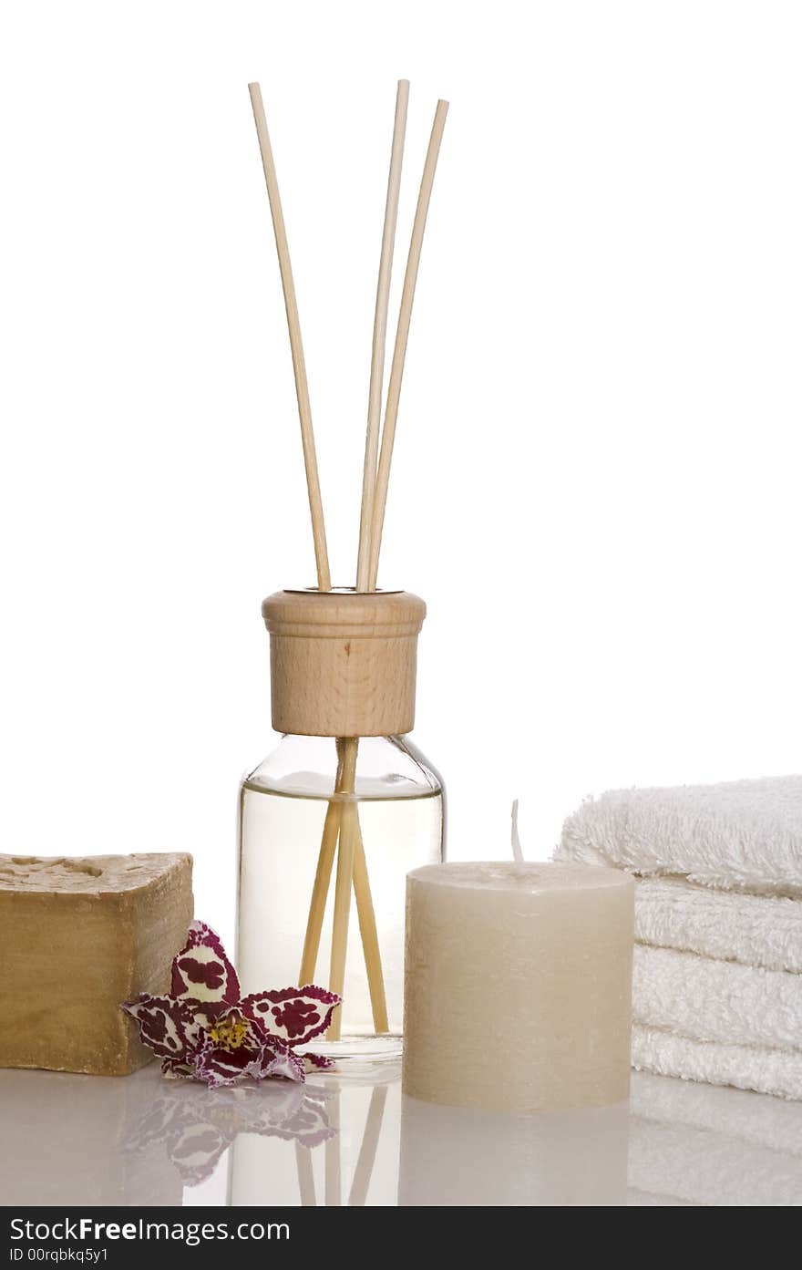 Aroma therapy objects. bottle of esential oil, candle, towels, soap, orchid