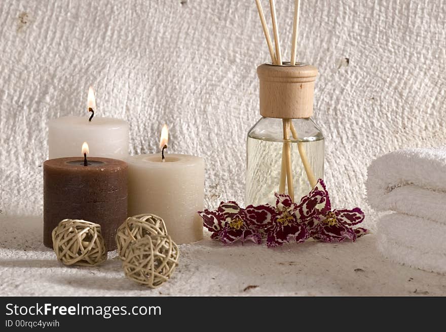 Aroma therapy objects. bottle of esential oil, candles, bath-salt, towels, orchid