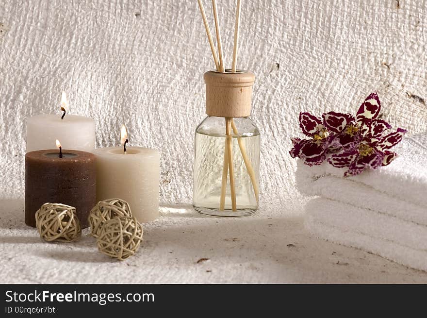 Aroma therapy objects. bottle of esential oil, candles, bath-salt, towels, orchid