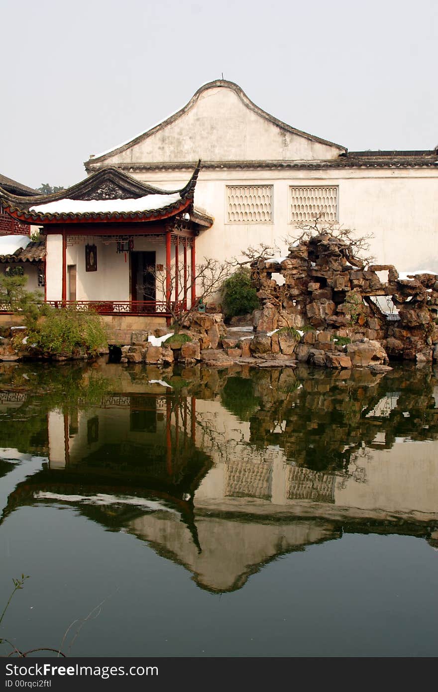 A pavilion with it's beautiful surroundings and their reflection in the water.This picture is taken in Net lion park in Suzhou ,China.