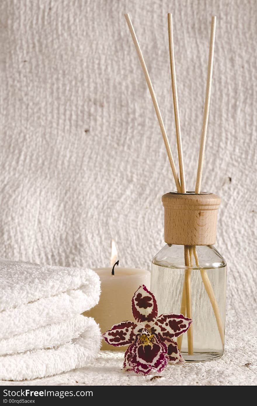 Aroma therapy objects. bottle of esential oil, candles, towels, orchid