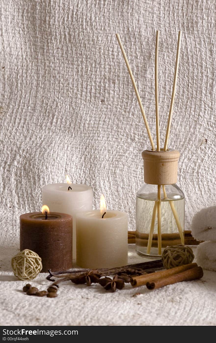 Aroma therapy objects. bottle of esential oil, candles, bath-salt, towels, coffee, vanilla, anise - stars