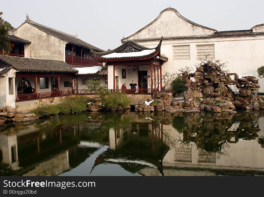 A pavilion with it's beautiful surroundings and their reflection in the water.This picture is taken in Net lion park in Suzhou ,China.