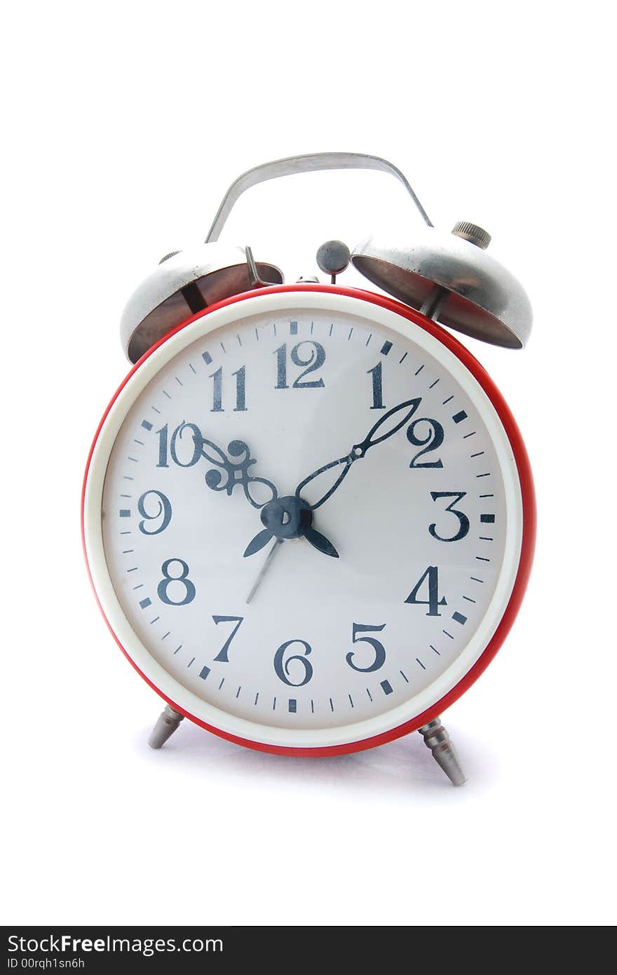 Old red alarm clock on a white background