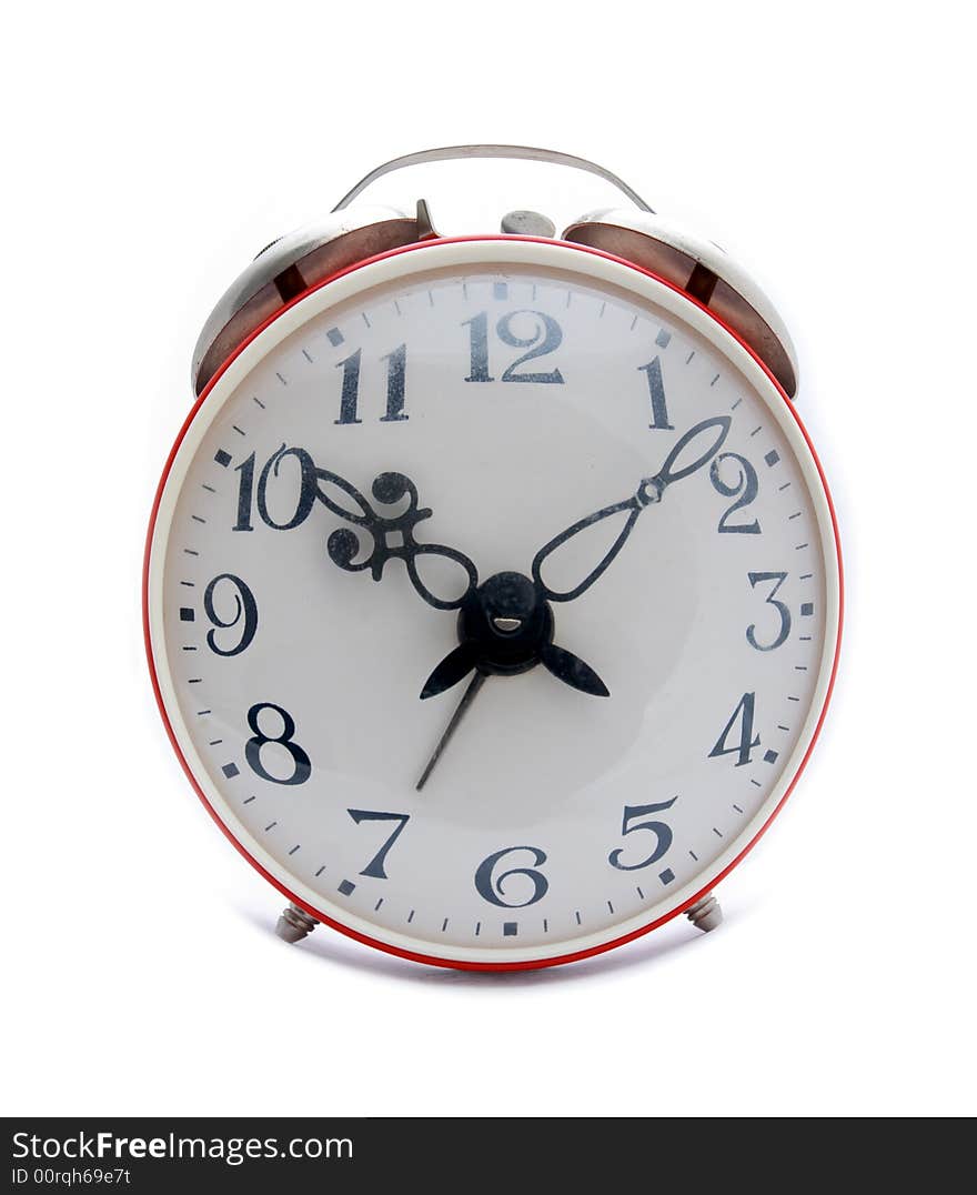 Old red alarm clock on a white background