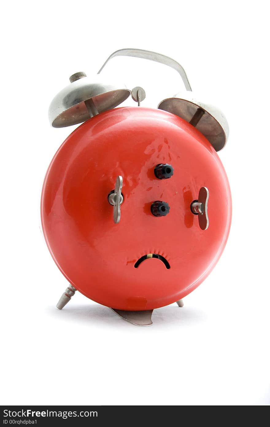 Old red alarm clock on a white background