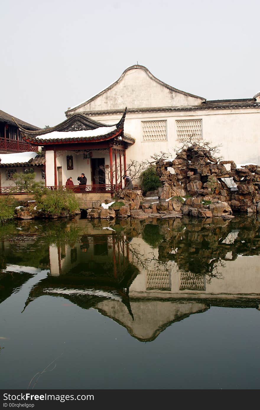 A pavilion with it's beautiful surroundings and their reflection in the water.This picture is taken in Net lion park in Suzhou ,China.