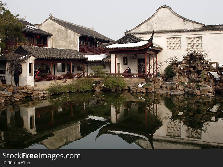 A pavilion with it's beautiful surroundings and their reflection in the water.This picture is taken in Net lion park in Suzhou ,China.