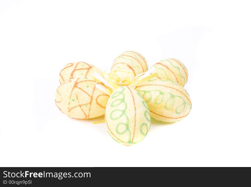 Yellow painted easter eggs on white background