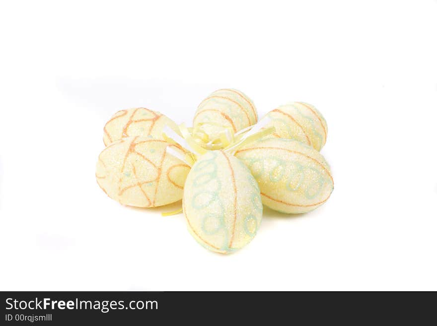 Yellow painted easter eggs on white background