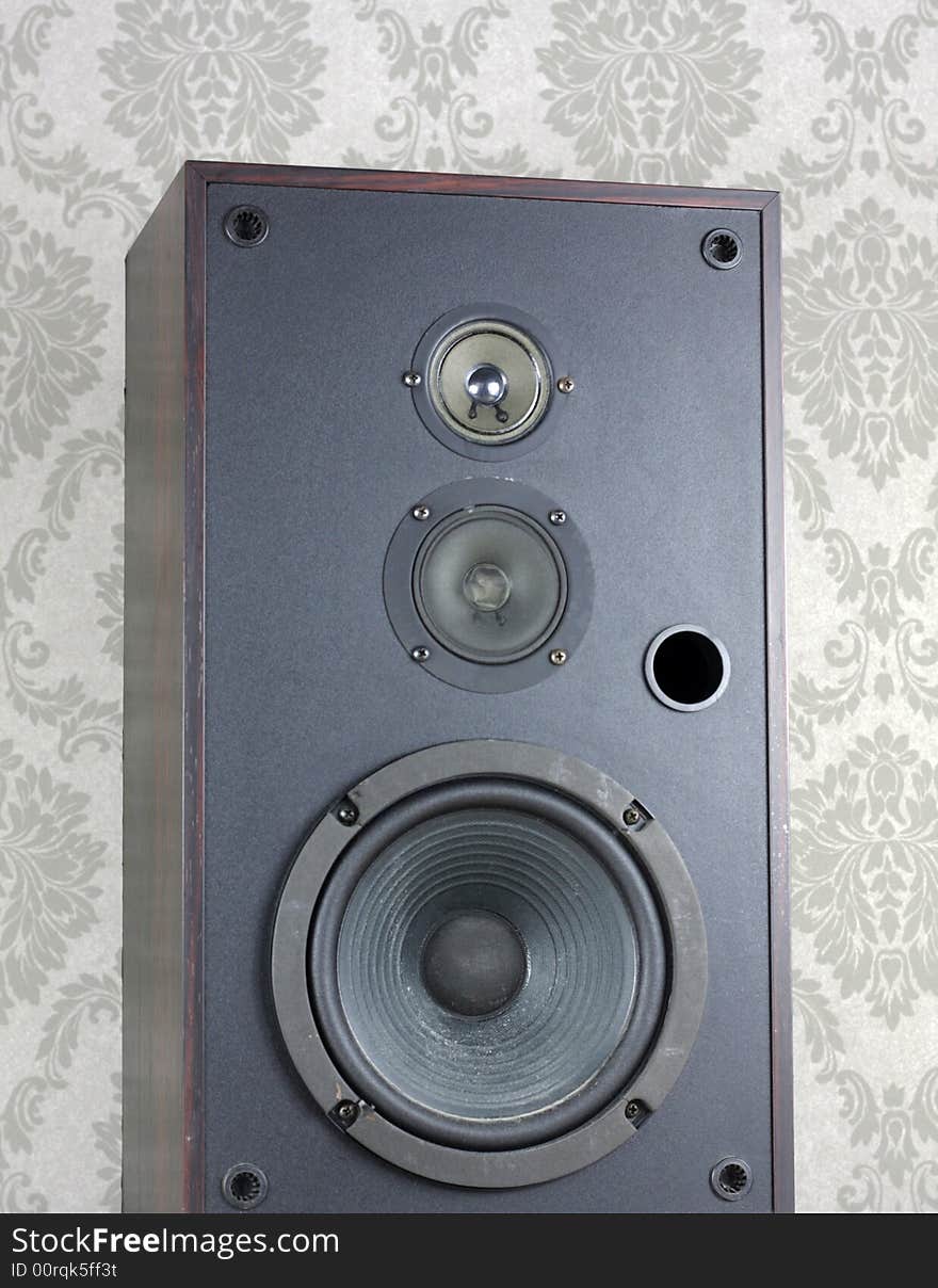 Audio speaker against grey wallpaper