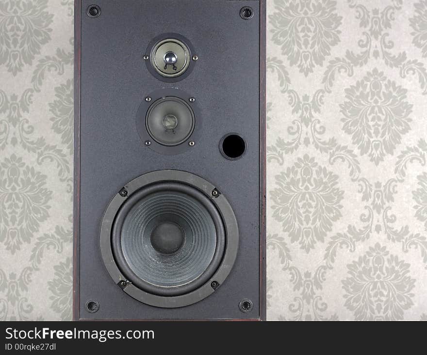 Audio speaker against grey wallpaper