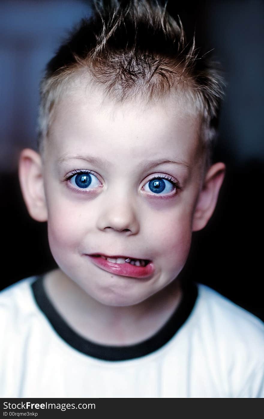 Child with big blue eyes in a T-shirt