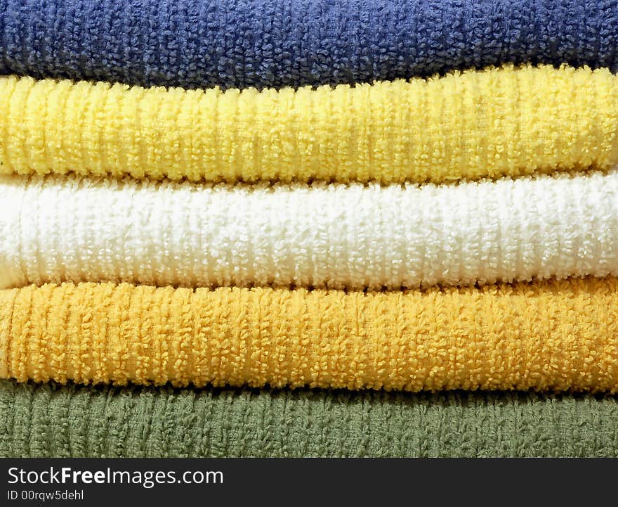 A group of colorful stacked cotton towels