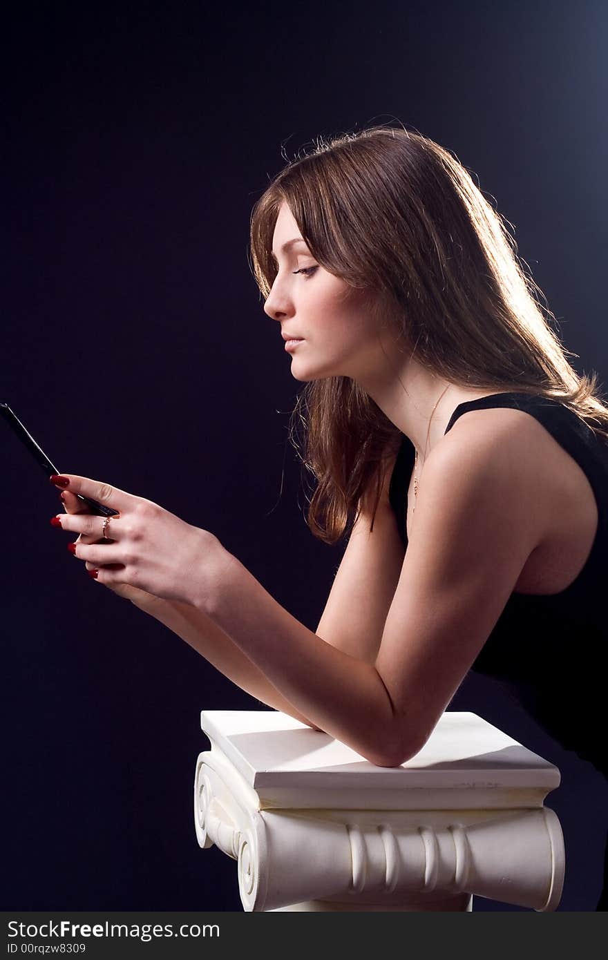 Lady in black handing mobile phone. Lady in black handing mobile phone