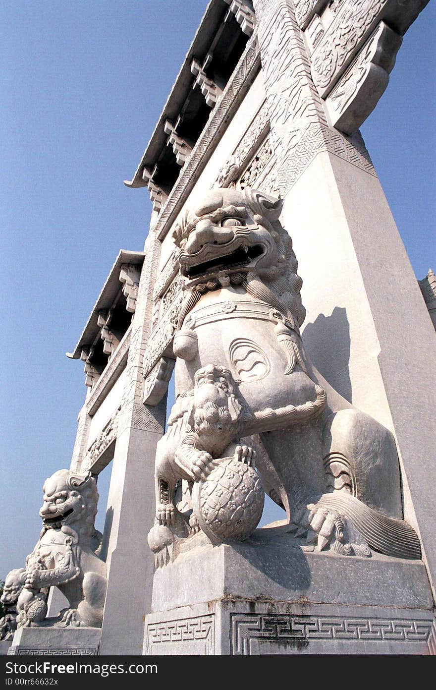 the Marble lions statue at the gate of a Buddist temple, of Chinese ancient traditonal architechture building art.The lion looks powerful ,stately and majestic. the Marble lions statue at the gate of a Buddist temple, of Chinese ancient traditonal architechture building art.The lion looks powerful ,stately and majestic.