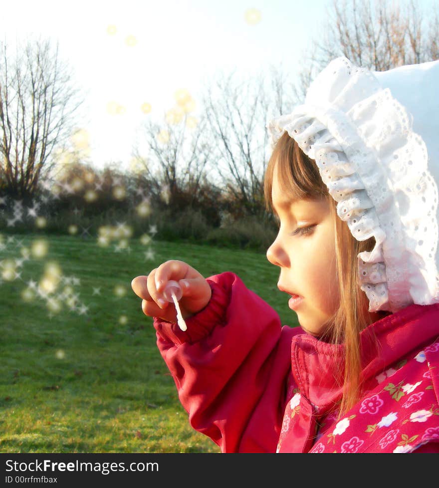 A little girl blowing bubbles