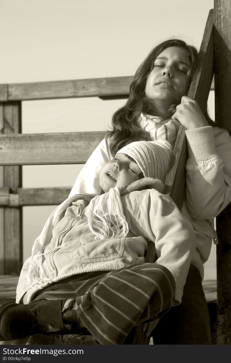 Two children resting on a pier