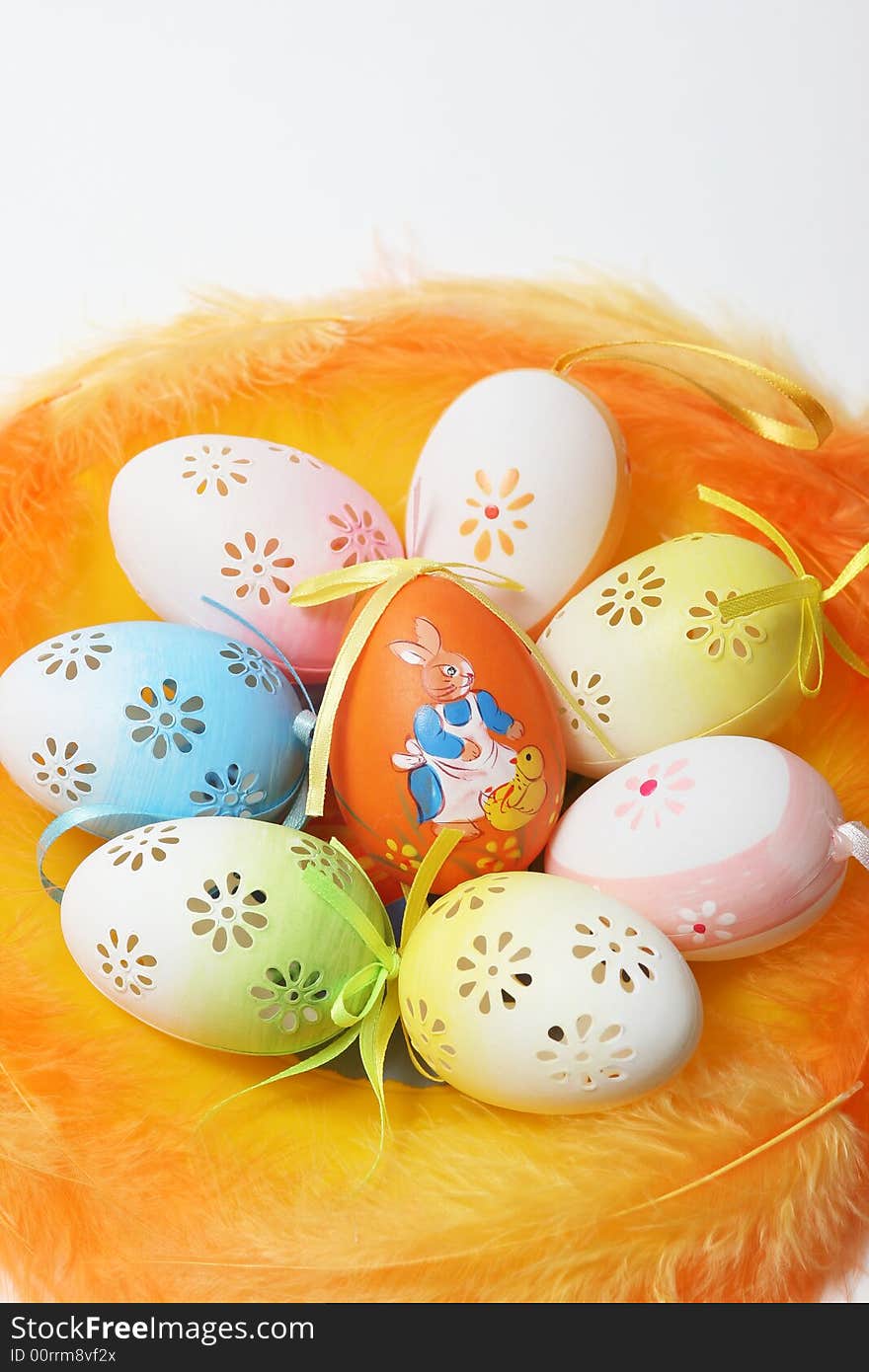 Easter eggs with yellow and orange feathers.