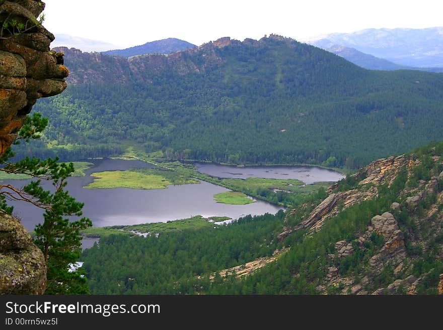 Mountain landscape, in the afternoon, with a kind on lake. Mountain landscape, in the afternoon, with a kind on lake.