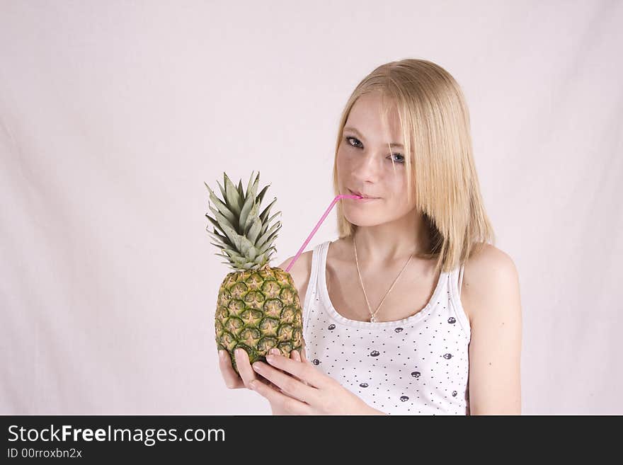 Teen drinking from a pineapple. Teen drinking from a pineapple