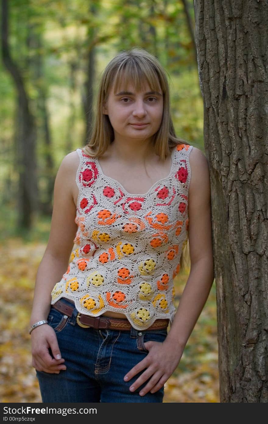 Portrait of the beautiful girl in autumn forest.