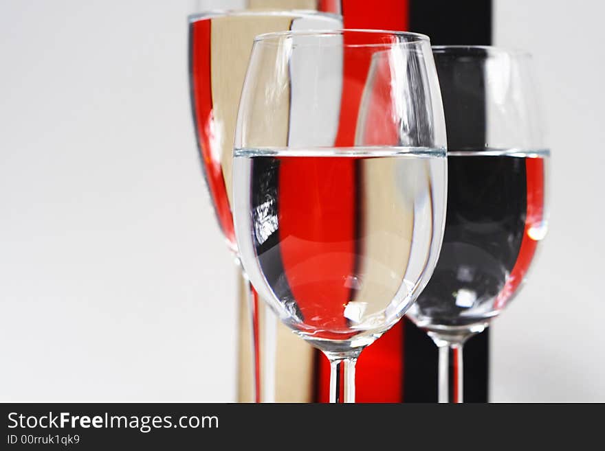 Champagne glasses detail against a color stripe background. Champagne glasses detail against a color stripe background