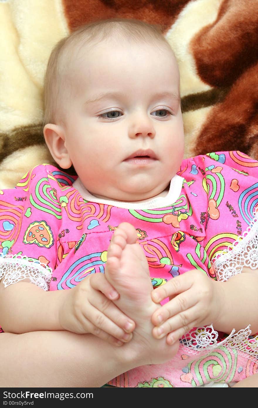 Happy baby lays on bed