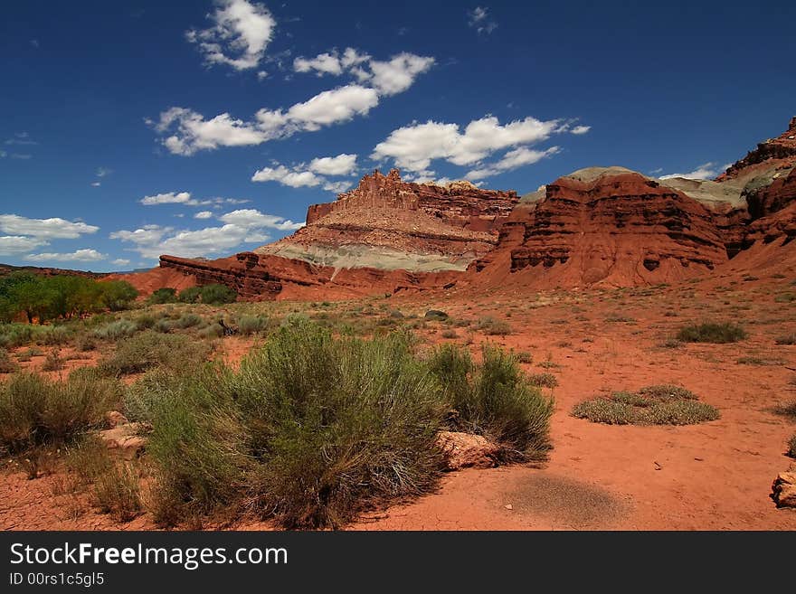 View of the red rock formations in Capitol Reef National Park with blue sky�s and clouds. View of the red rock formations in Capitol Reef National Park with blue sky�s and clouds