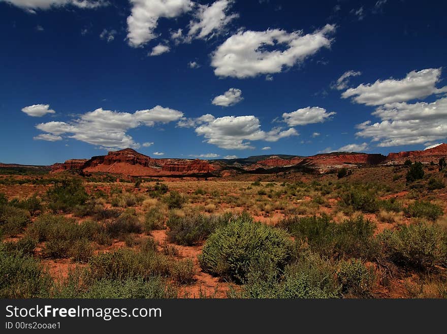 View of the red rock formations in Capitol Reef National Park with blue sky�s and clouds. View of the red rock formations in Capitol Reef National Park with blue sky�s and clouds