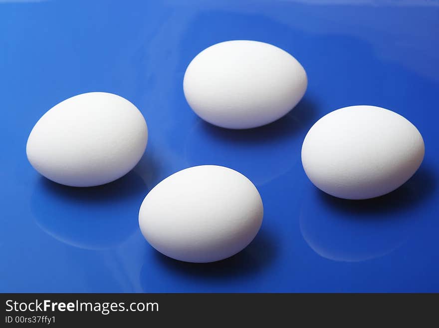 White eggs on blue background. White eggs on blue background.