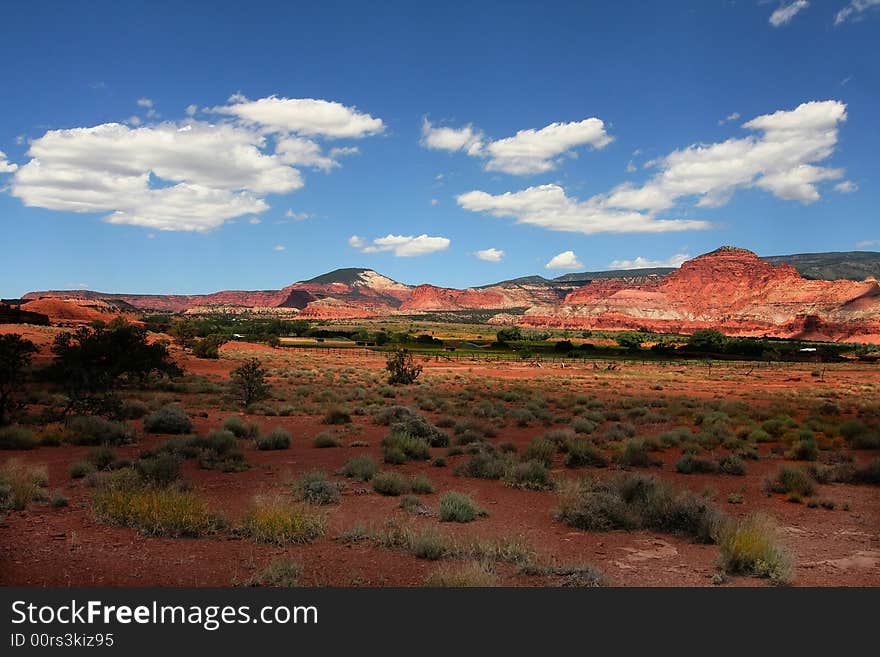 View of the red rock formations in Capitol Reef National Park with blue sky�s and clouds. View of the red rock formations in Capitol Reef National Park with blue sky�s and clouds