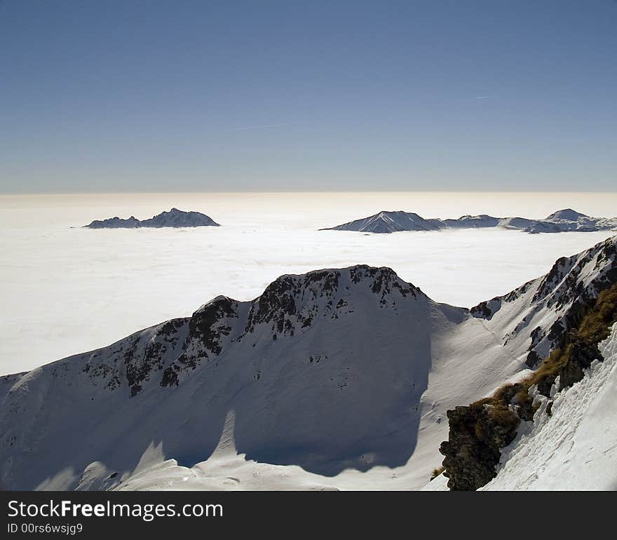 On the top of a mountain above the clouds seem to be in paradise