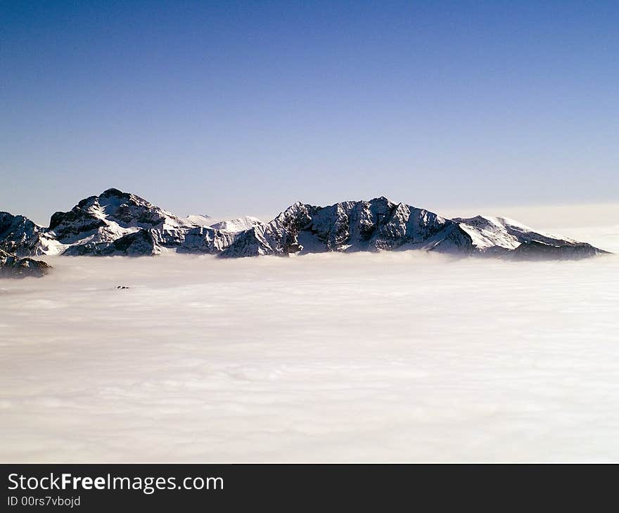 On the top of a mountain above the clouds seem to be in paradise