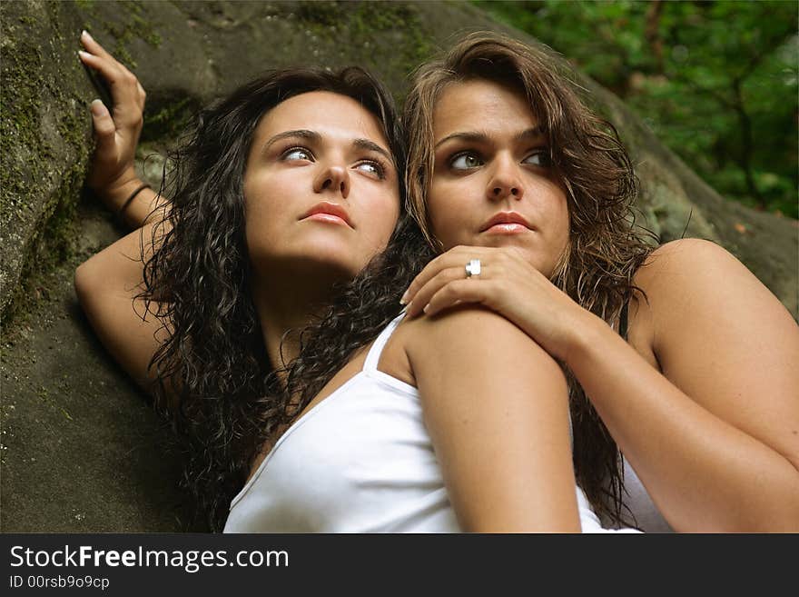 Two sisters in nature looking in the same direction